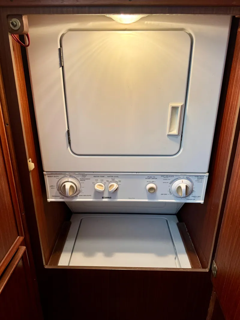 Slide: The Image of 1984 Hatteras Motor Yacht laundry area with washer and dryer unit. - 19