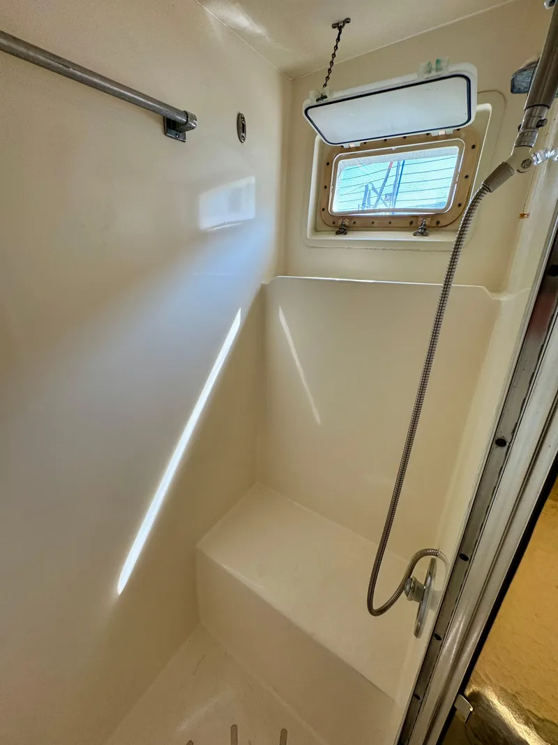 Slide: The Image of 1984 Hatteras Motor Yacht shower with window and handheld showerhead. - 21