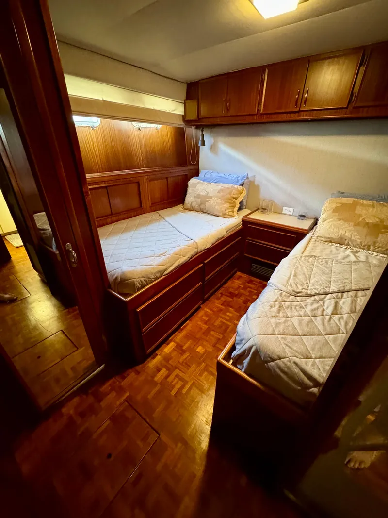 Slide: The Image of 1984 Hatteras Motor Yacht cabin with twin beds and wooden interior. - 24