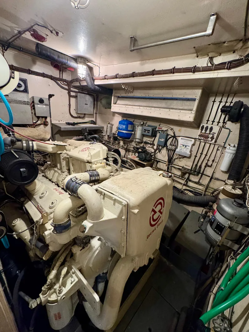 Slide: The Image of Engine room of a 1984 Hatteras Motor Yacht with visible machinery and piping. - 26