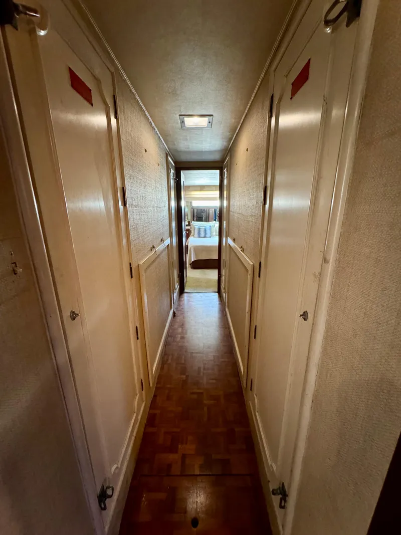 Slide: The Image of Narrow hallway inside 1984 Hatteras Motor Yacht, leading to a bedroom. - 27