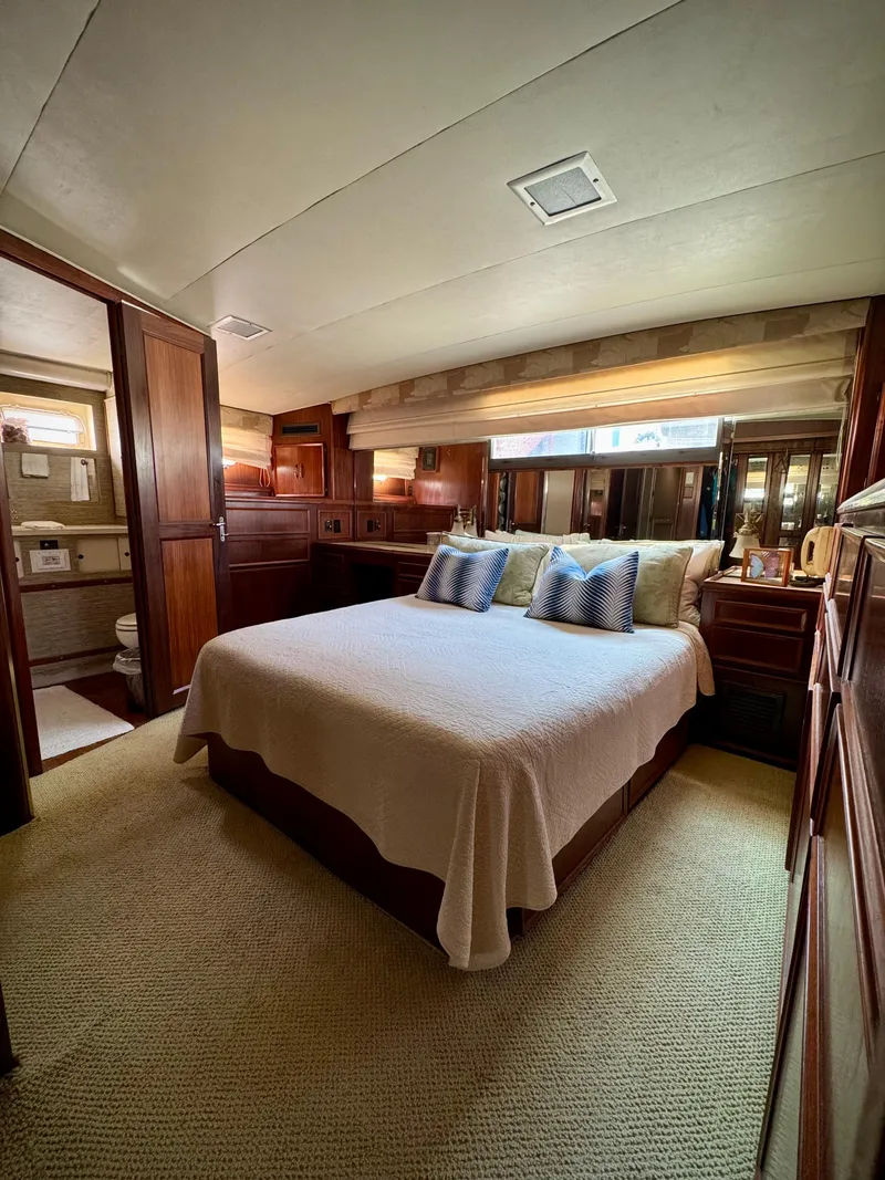 Slide: The Image of Luxurious bedroom interior of 1984 Hatteras Motor Yacht with elegant wood finishes. - 29