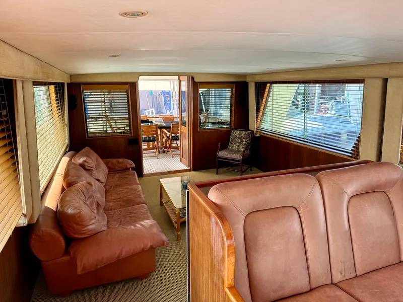 Slide: The Image of 1984 Hatteras Motor Yacht interior with leather seating and wooden accents. - 3