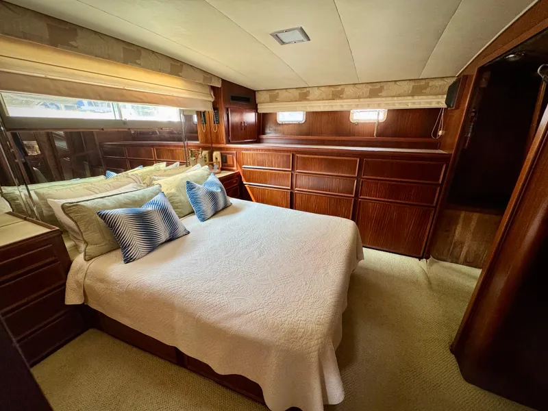 Slide: The Image of Luxurious bedroom interior of 1984 Hatteras Motor Yacht with elegant wood paneling. - 30