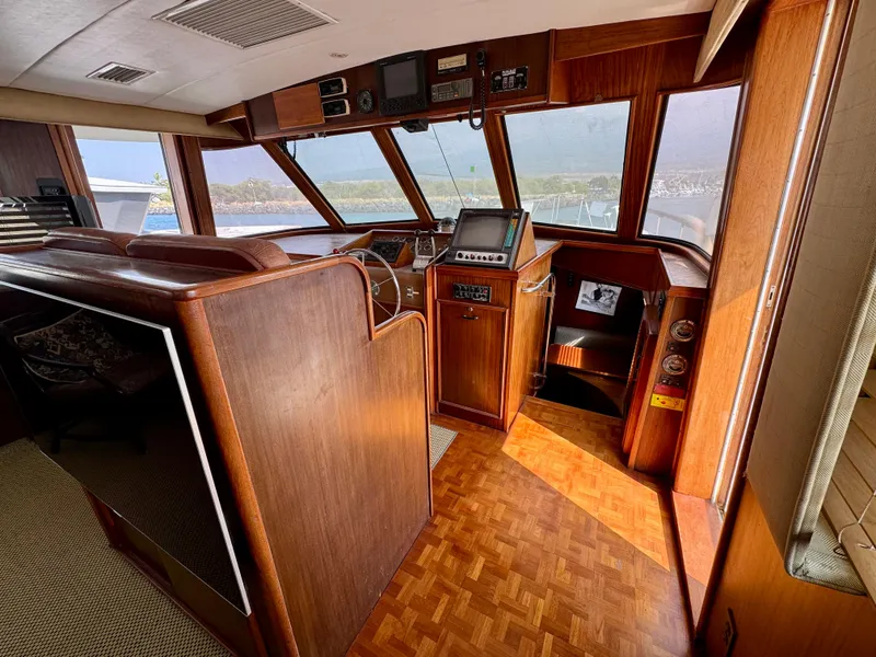 Slide: The Image of 1984 Hatteras Motor Yacht interior with wood paneling and navigation equipment. - 4