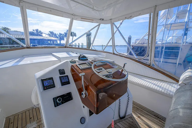 Slide: The Image of Interior helm of 2008 Jersey Cape Devil 36 boat with wooden steering wheel. - 16