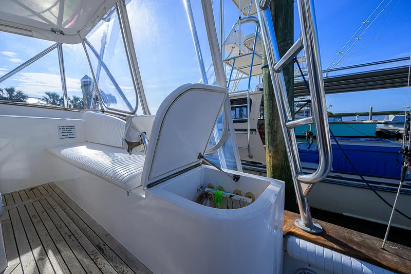Slide: The Image of 2008 Jersey Cape Devil 36 boat interior with seating and storage, docked at marina. - 21