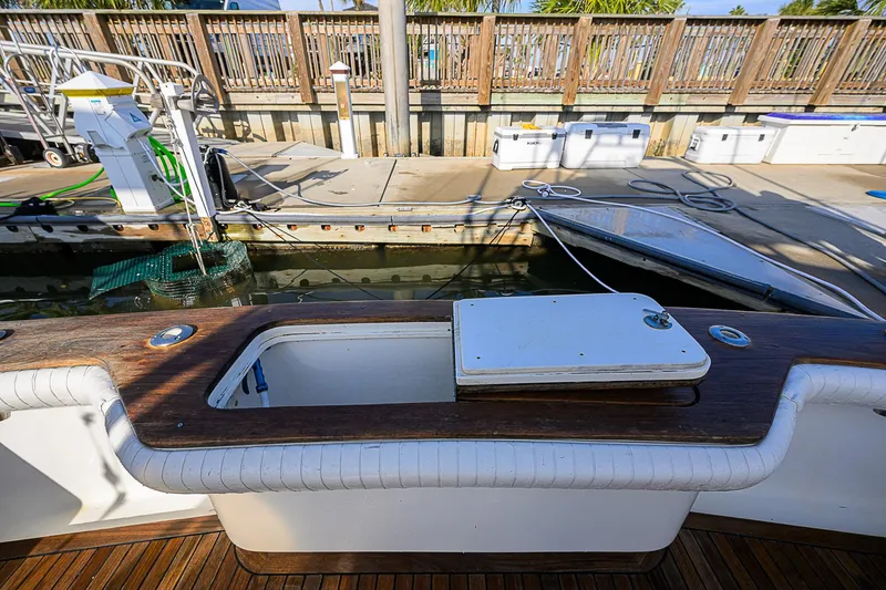 Slide: The Image of 2008 Jersey Cape Devil 36 boat at dock with open storage compartment. - 22