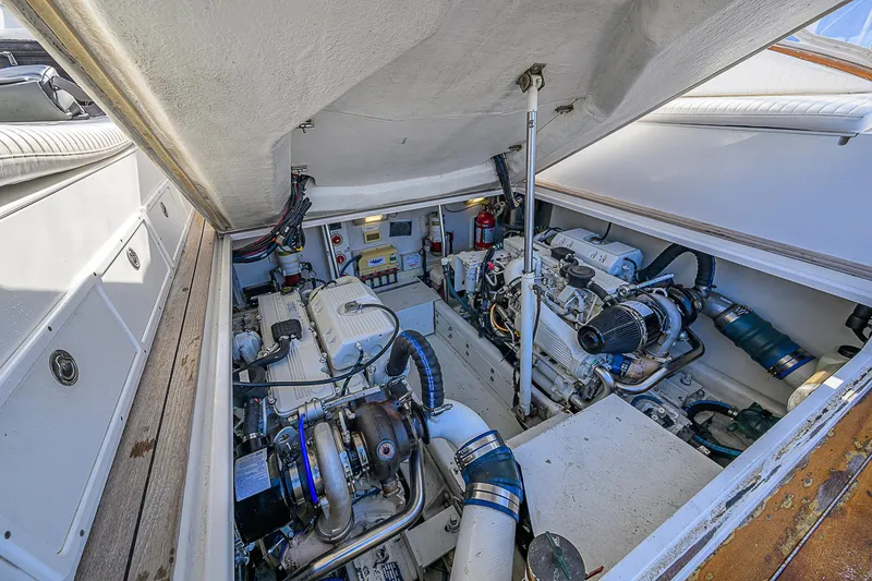 Slide: The Image of Engine compartment of 2008 Jersey Cape Devil 36 boat, showcasing dual engines and mechanical components. - 26