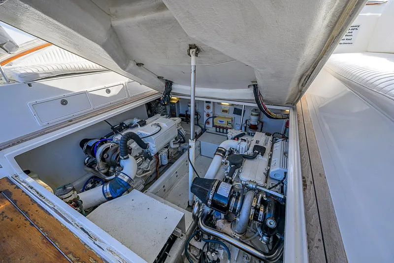 Slide: The Image of Engine compartment of 2008 Jersey Cape Devil 36 boat, showcasing dual engines and mechanical components. - 27