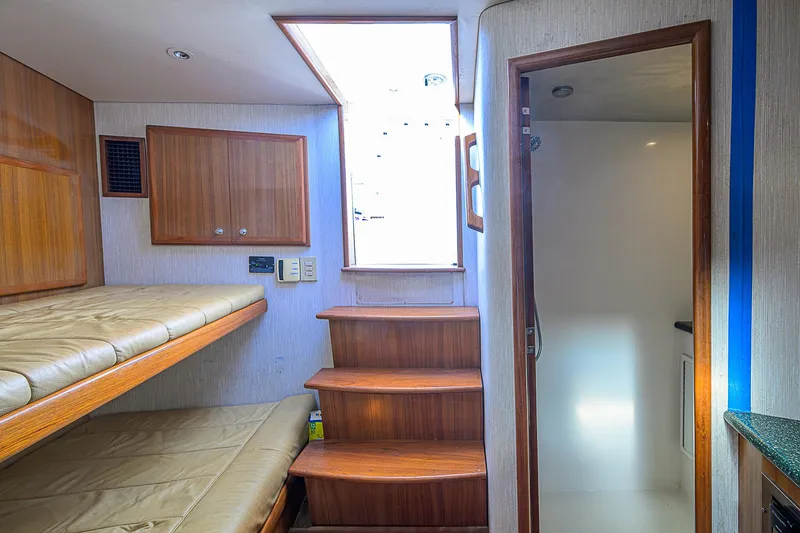 Slide: The Image of Interior of 2008 Jersey Cape Devil 36 with wooden bunk beds and stairs. - 30