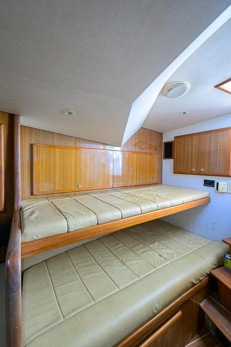 Slide: The Image of Interior of 2008 Jersey Cape Devil 36 with wooden bunk beds and storage cabinets. - 31