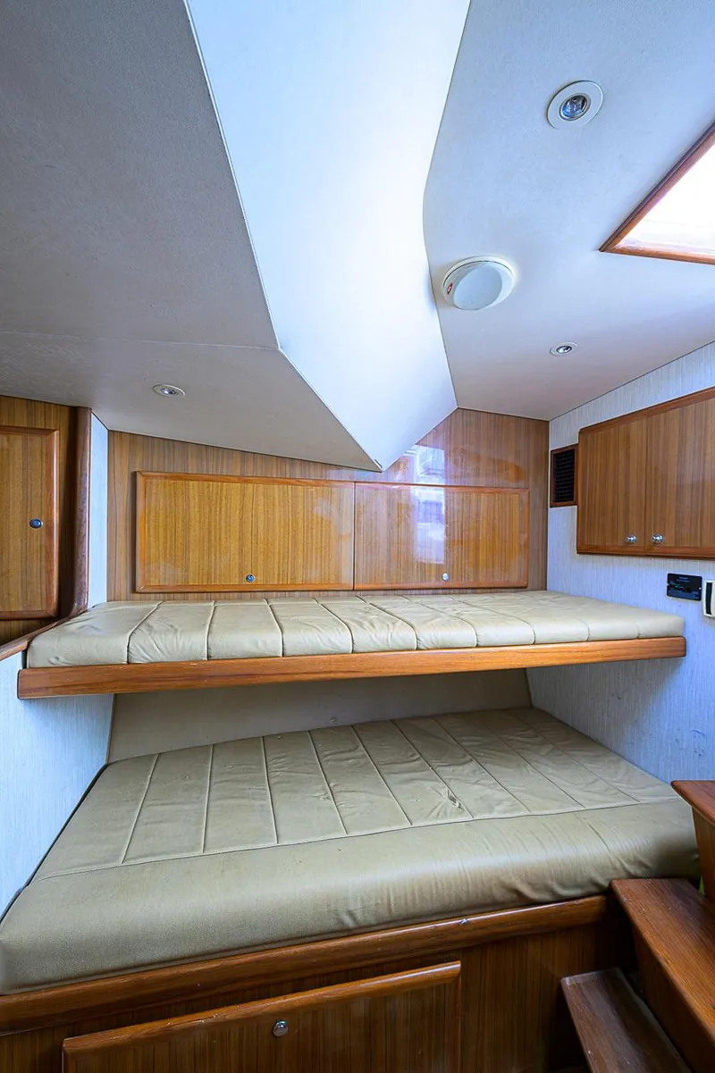 Slide: The Image of Interior cabin of 2008 Jersey Cape Devil 36 with wooden bunk beds. - 32