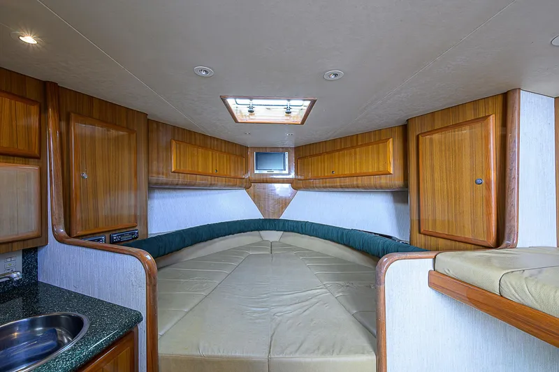 Slide: The Image of Interior of 2008 Jersey Cape Devil 36 boat with wood cabinets and cozy seating area. - 33
