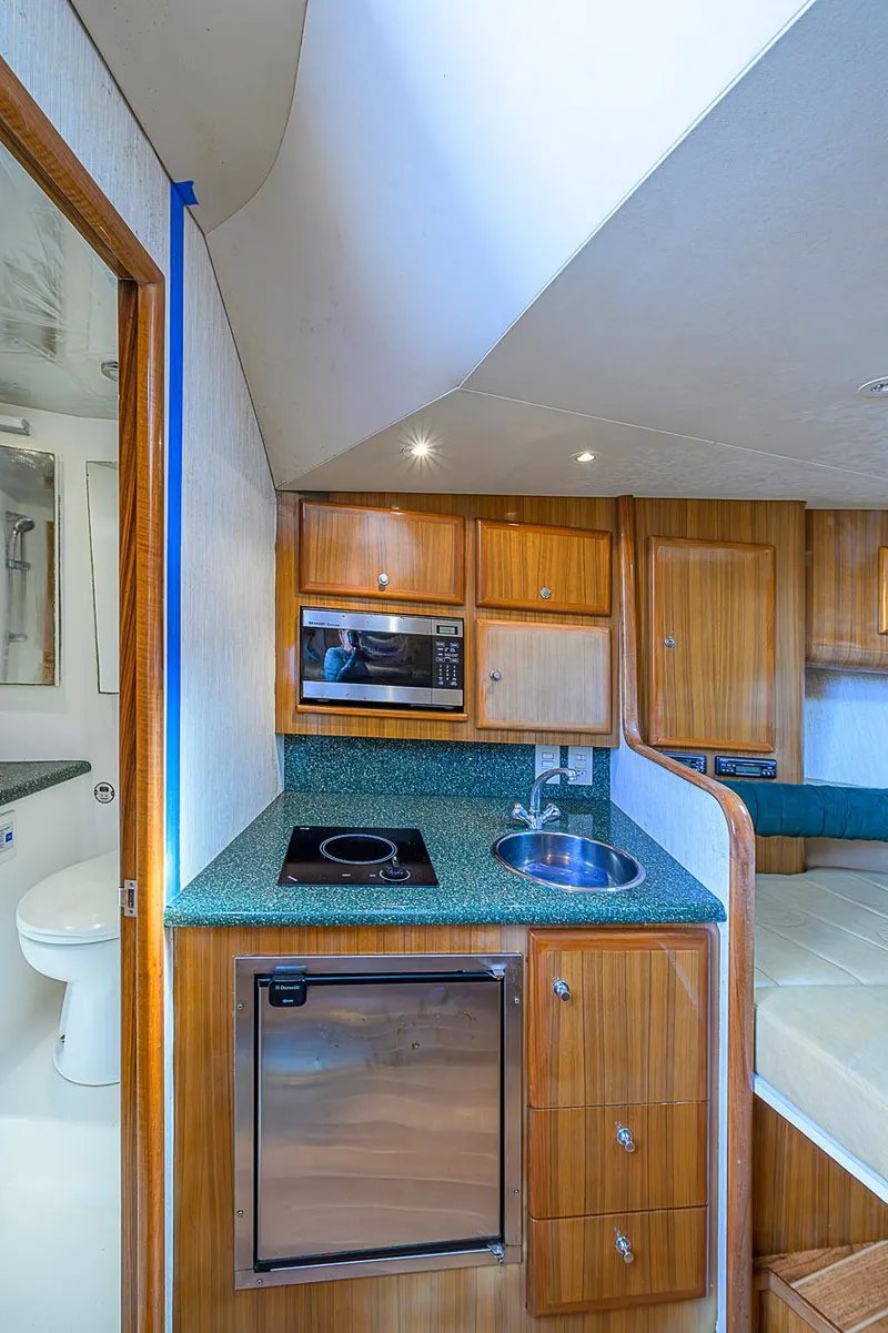 Slide: The Image of 2008 Jersey Cape Devil 36 yacht interior with kitchenette and modern amenities. - 34
