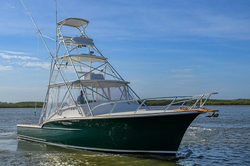 Slide: The Image of 2008 Jersey Cape Devil 36 boat cruising on calm waters under a clear sky. - 6