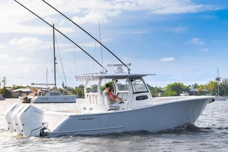 Slide: The Image of 2025 Phenom 34 boat cruising on a sunny day with clear skies. - 1