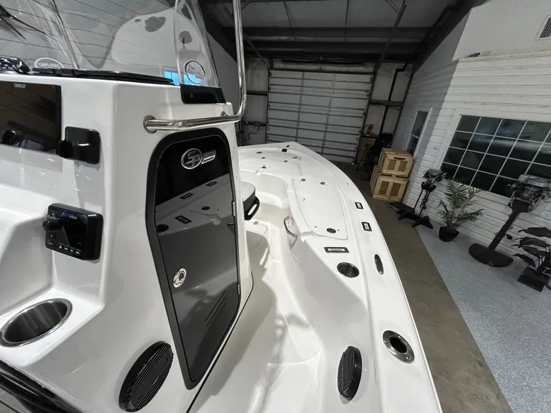 Slide: The Image of 2025 Sea Pro 210 Bay boat interior in a garage setting. - 10