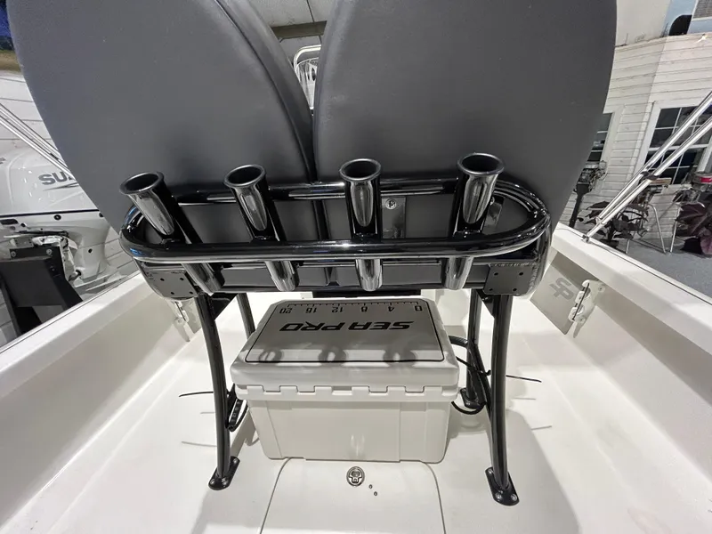 Slide: The Image of 2025 Sea Pro 210 Bay boat interior with rod holders and storage. - 16