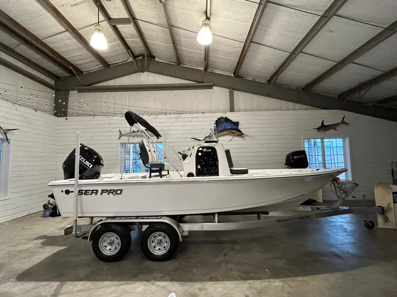 Slide: The Image of 2025 Sea Pro 210 Bay boat on trailer in a garage setting. - 2