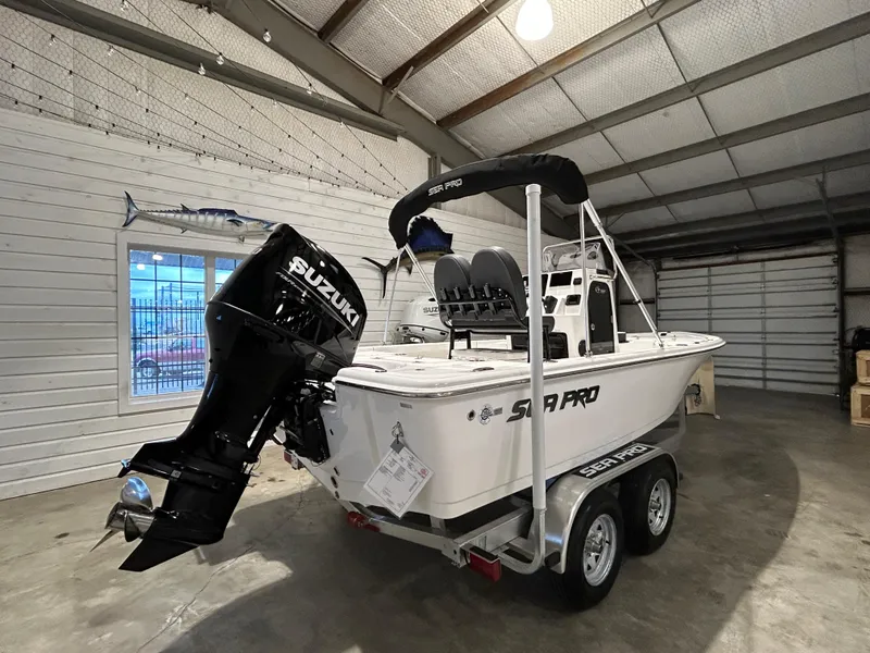 Slide: The Image of 2025 Sea Pro 210 Bay boat with Suzuki engine in a garage. - 5