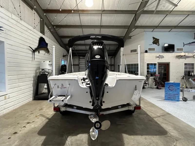 Slide: The Image of 2025 Sea Pro 210 Bay boat in showroom, rear view with motor and propeller. - 6