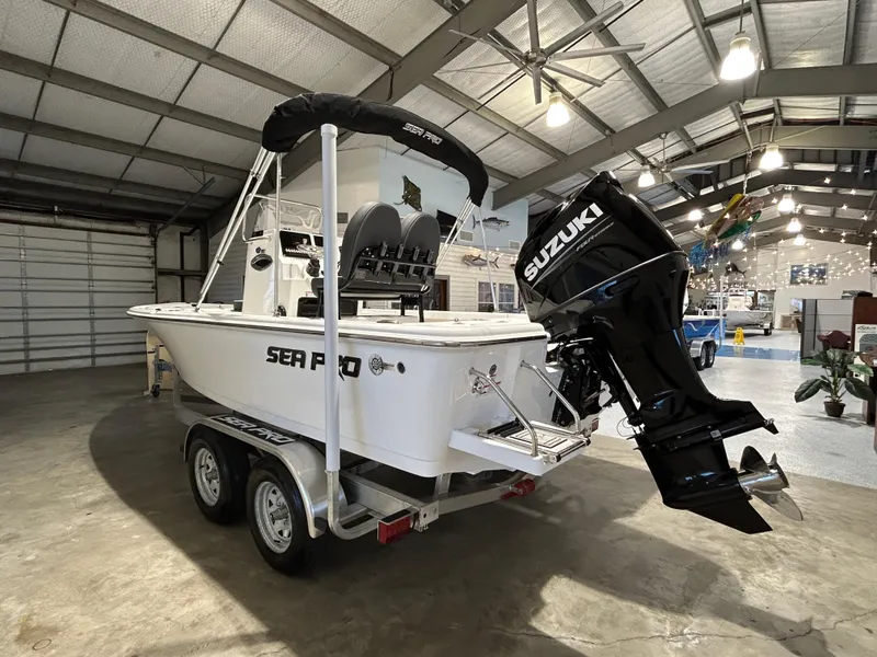 Slide: The Image of 2025 Sea Pro 210 Bay boat with Suzuki engine in a showroom. - 7