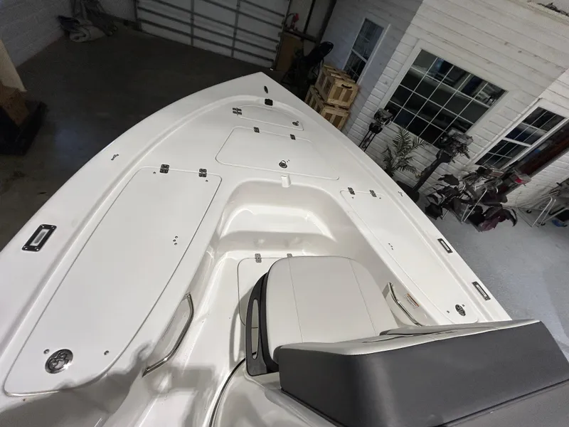 Slide: The Image of 2025 Sea Pro 210 Bay boat interior, featuring spacious deck and seating. - 8