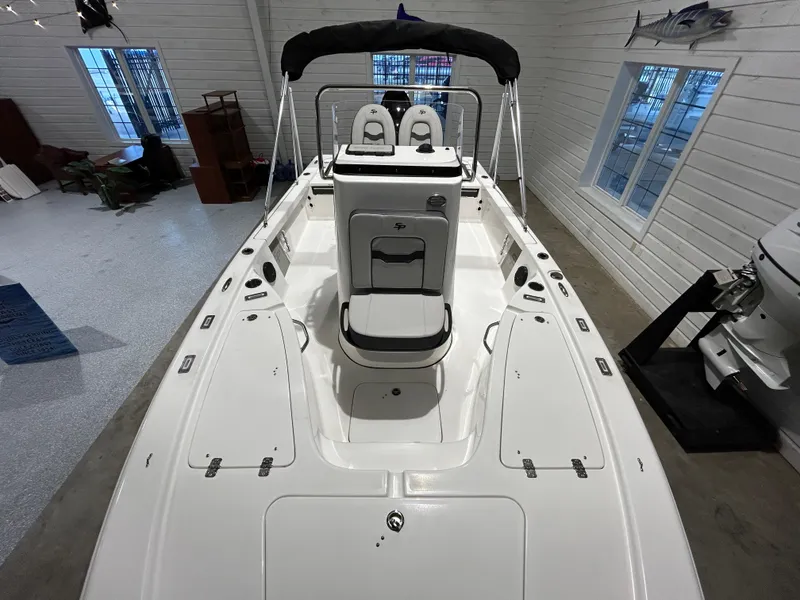 Slide: The Image of 2025 Sea Pro 210 Bay boat interior with seating and storage compartments. - 9