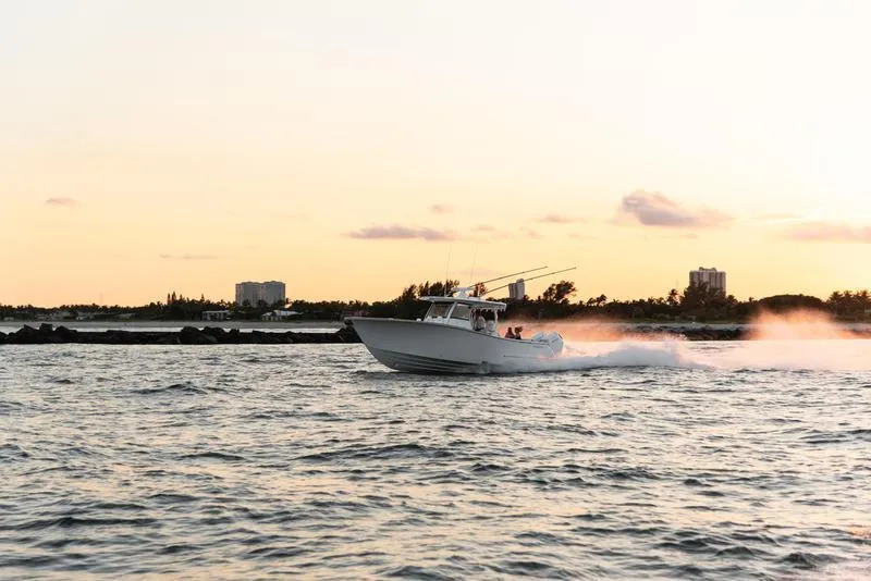 Slide: The Image of Phenom 37 boat cruising at sunset, 2025 model, on open water. - 0