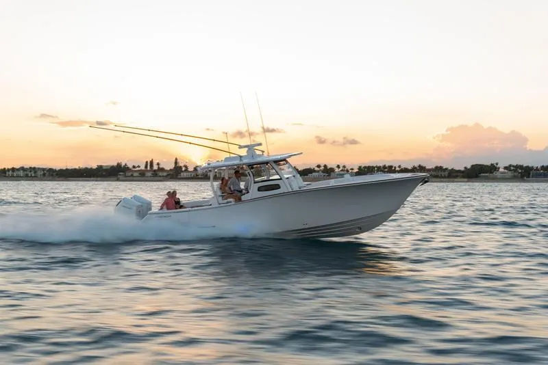 Slide: The Image of Phenom 37 boat cruising at sunset, 2025 model, on calm waters. - 1