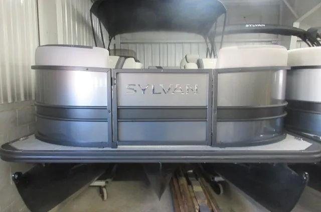 The Image of 2025 Sylvan L3 DLZ pontoon boat in storage, showcasing sleek design and modern features. - 0