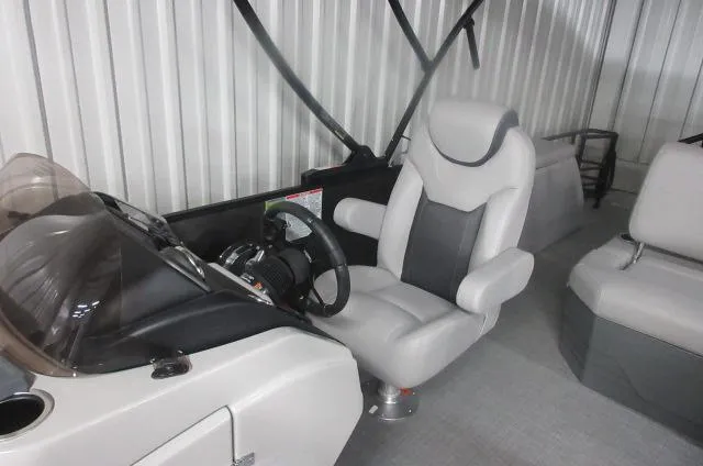 Slide: The Image of 2025 Sylvan L3 DLZ boat interior with modern steering console and comfortable seating. - 6