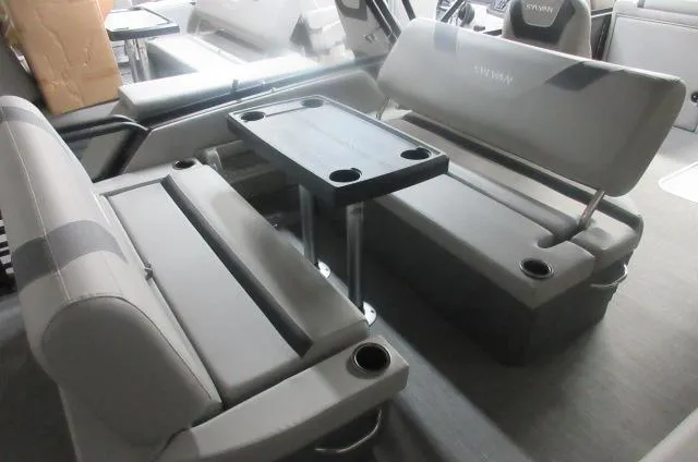 Slide: The Image of 2025 Sylvan L3 DLZ boat interior with gray seating and a central table. - 9
