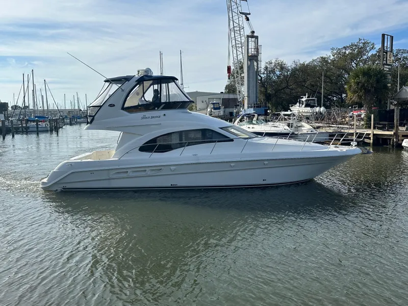 The Image of 2007 Sea Ray 44 Sedan Bridge yacht docked in marina. - 0