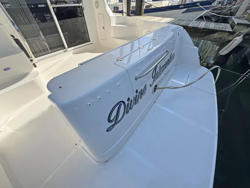 Slide: The Image of 2007 Sea Ray 44 Sedan Bridge yacht, docked, featuring "Divine Intervention" name on stern. - 12