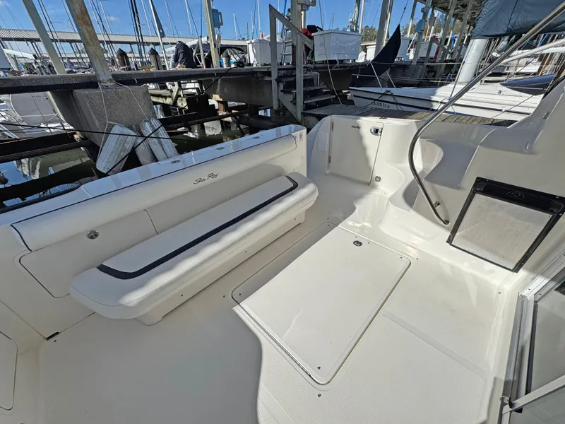 Slide: The Image of 2007 Sea Ray 44 Sedan Bridge yacht deck with seating at marina. - 13