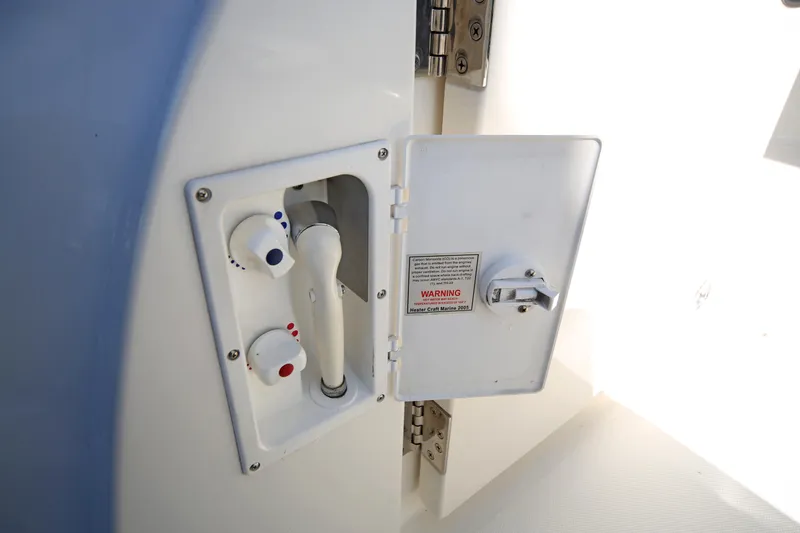Slide: The Image of 2007 Sea Ray 44 Sedan Bridge shower controls in open compartment. - 15