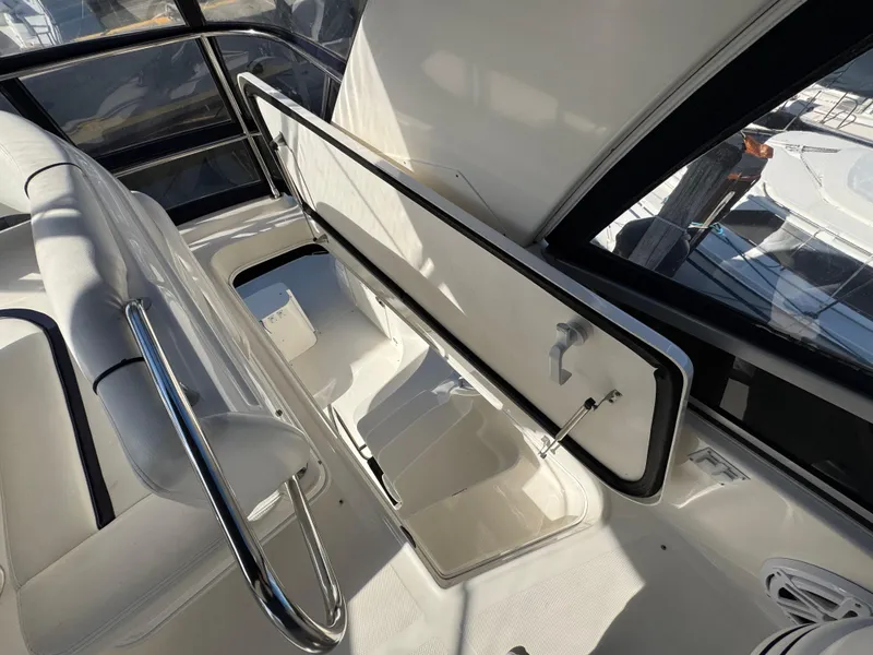 Slide: The Image of 2007 Sea Ray 44 Sedan Bridge interior with seating and storage compartment. - 18