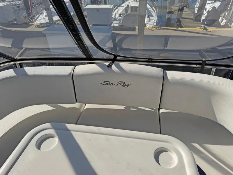 Slide: The Image of 2007 Sea Ray 44 Sedan Bridge interior with white seating and table. - 23