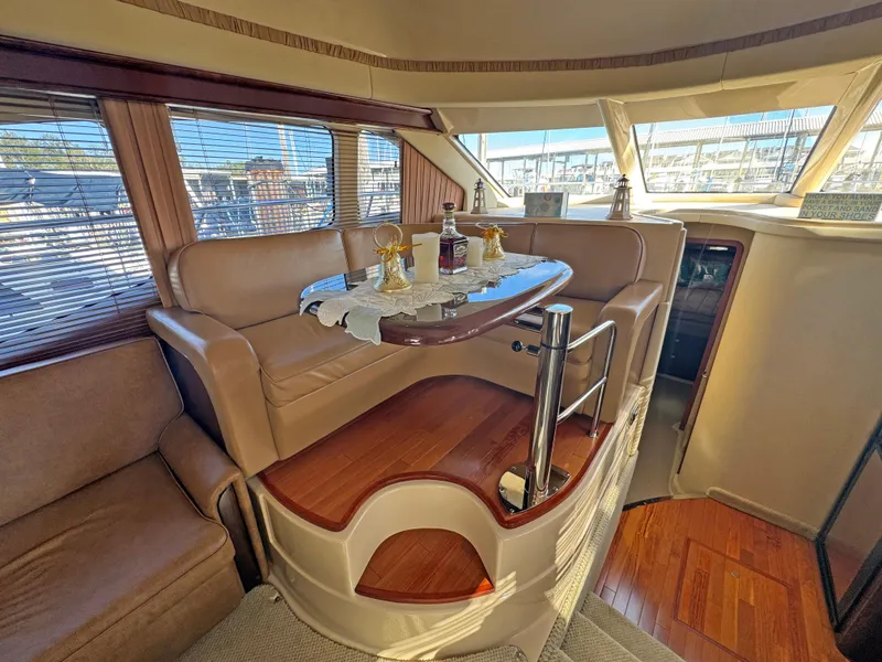 Slide: The Image of Luxurious interior of 2007 Sea Ray 44 Sedan Bridge yacht with elegant seating and dining area. - 35