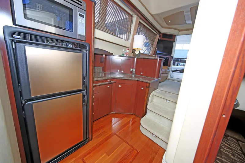 Slide: The Image of Interior of 2007 Sea Ray 44 Sedan Bridge yacht with modern kitchen and wood flooring. - 39