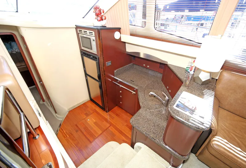 Slide: The Image of Interior of 2007 Sea Ray 44 Sedan Bridge yacht with modern kitchen amenities. - 40