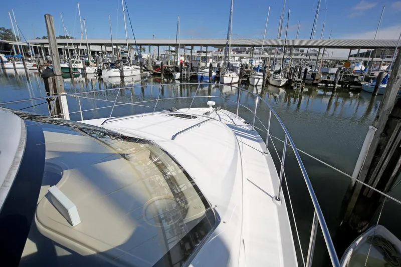 Slide: The Image of 2007 Sea Ray 44 Sedan Bridge yacht docked in a marina with sailboats. - 5
