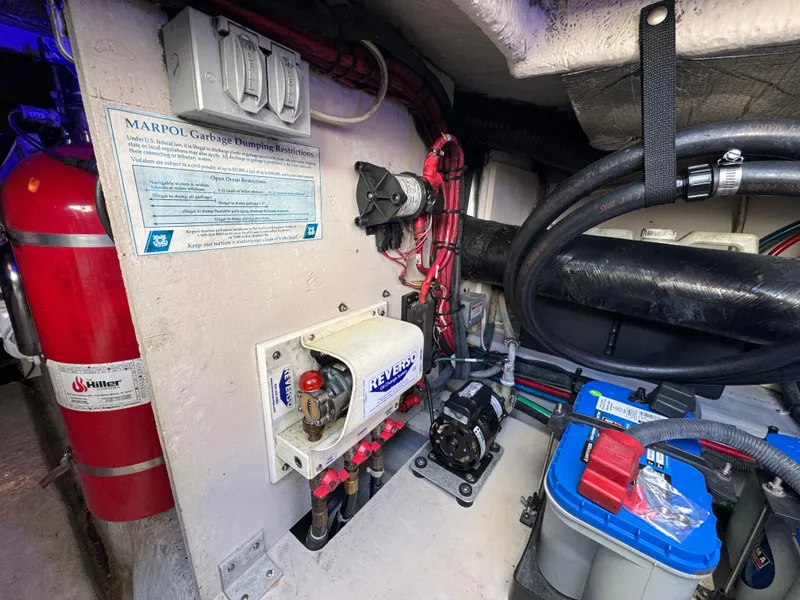 Slide: The Image of Engine room of 2007 Sea Ray 44 Sedan Bridge with safety equipment and electrical components. - 55