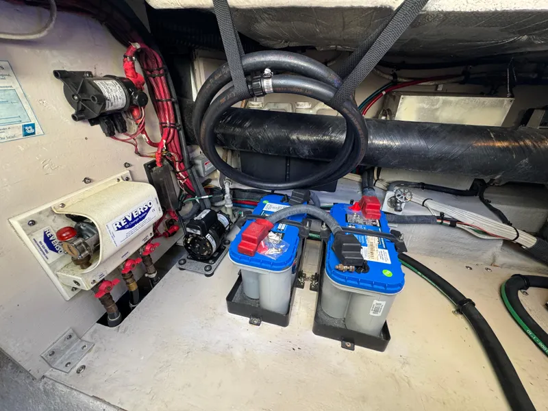 Slide: The Image of Engine compartment of 2007 Sea Ray 44 Sedan Bridge with batteries and wiring. - 56