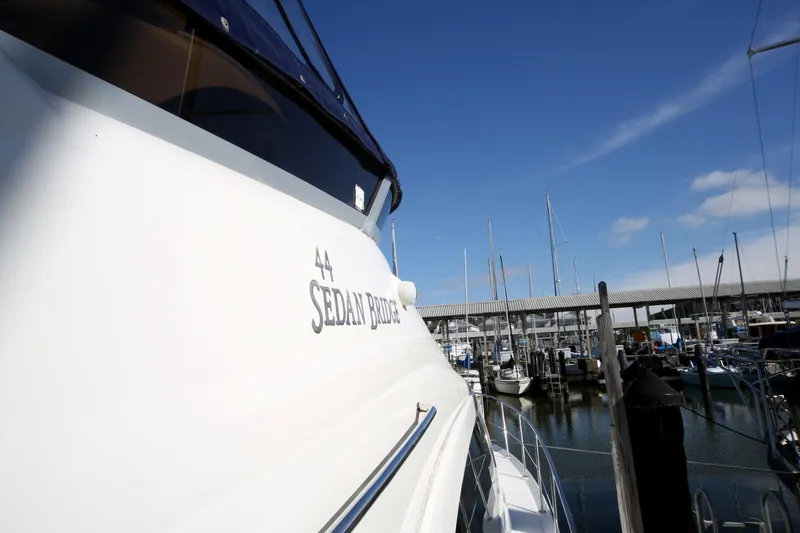Slide: The Image of 2007 Sea Ray 44 Sedan Bridge yacht docked at marina under clear blue sky. - 7