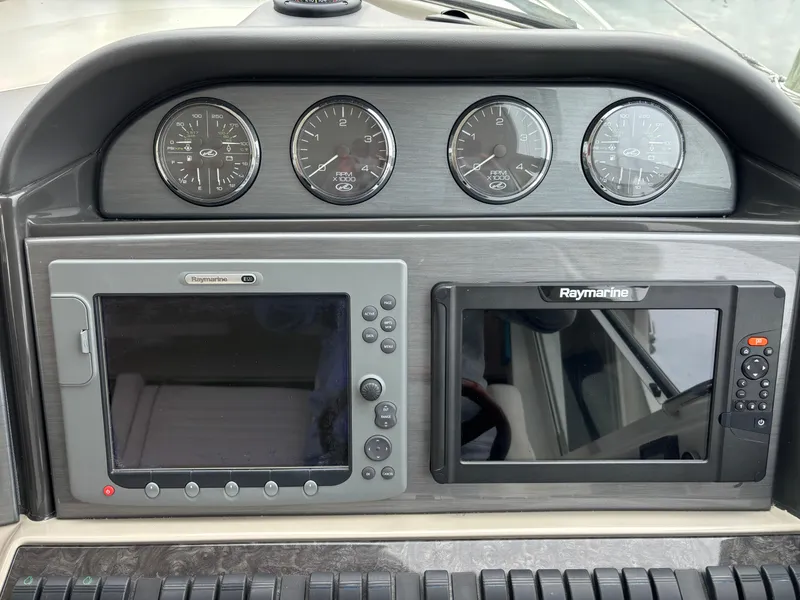 Slide: The Image of 2006 Sea Ray 40 Motor Yacht dashboard with Raymarine navigation displays and gauges. - 12
