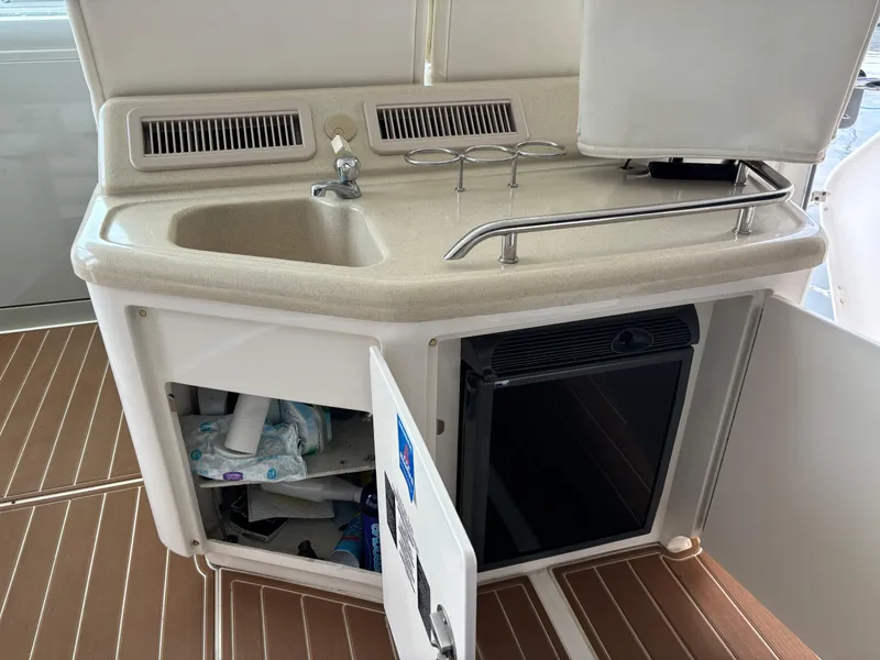 Slide: The Image of 2006 Sea Ray 40 Motor Yacht kitchenette with sink, storage, and mini fridge. - 14
