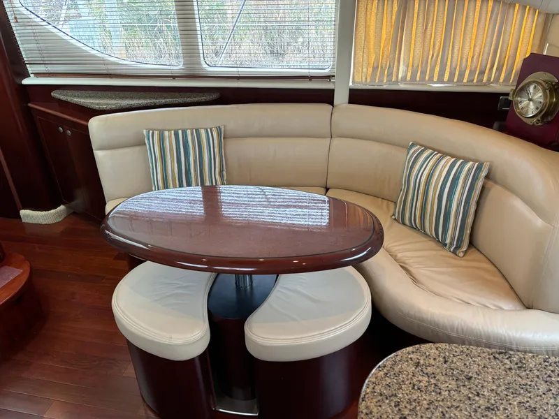 Slide: The Image of Luxurious 2006 Sea Ray 40 Motor Yacht interior with curved seating and elegant table. - 17